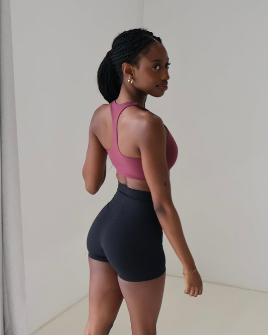 Back shot close up of slim back racer sports bra with minimal branding logo