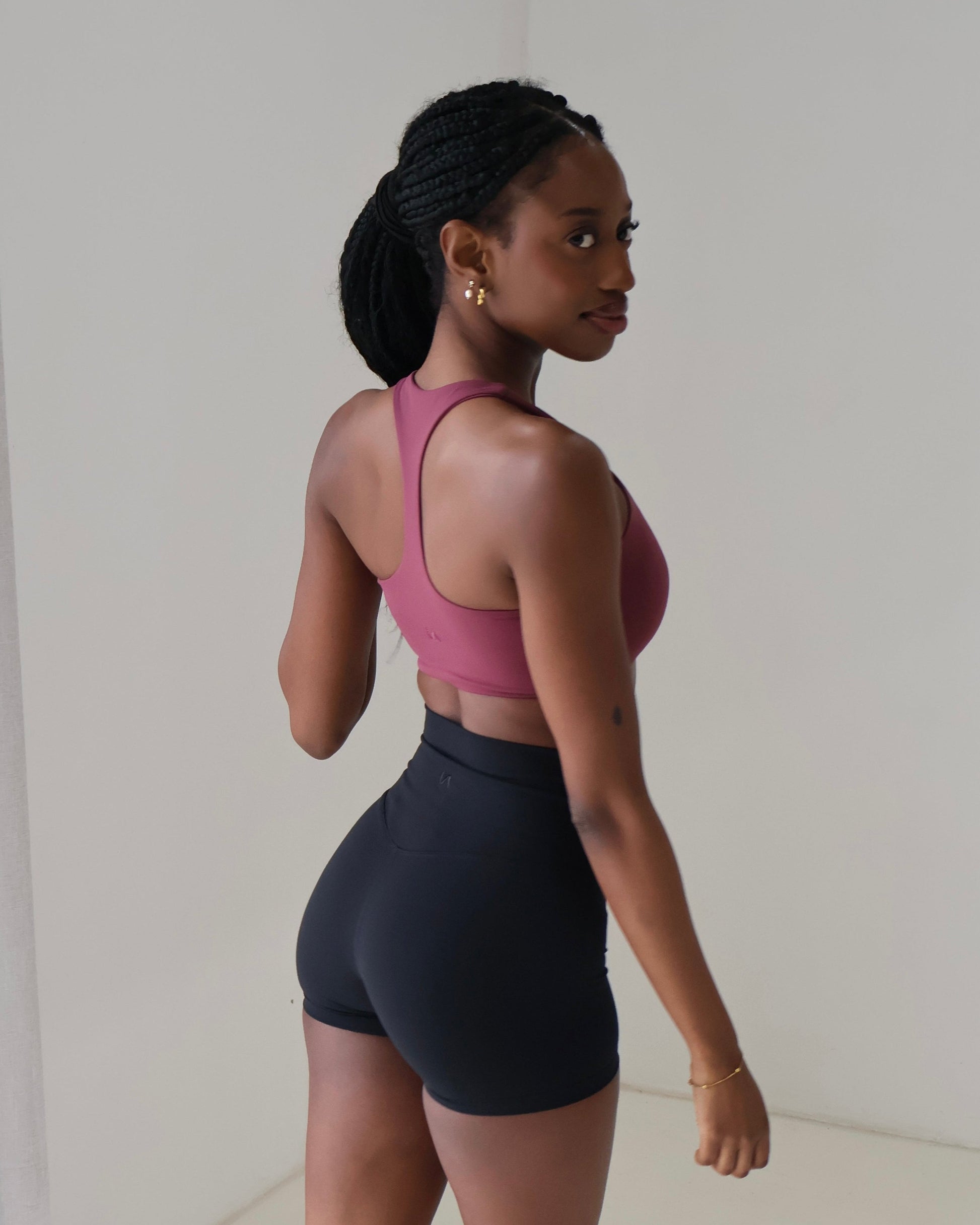 Back shot close up of slim back racer sports bra with minimal branding logo