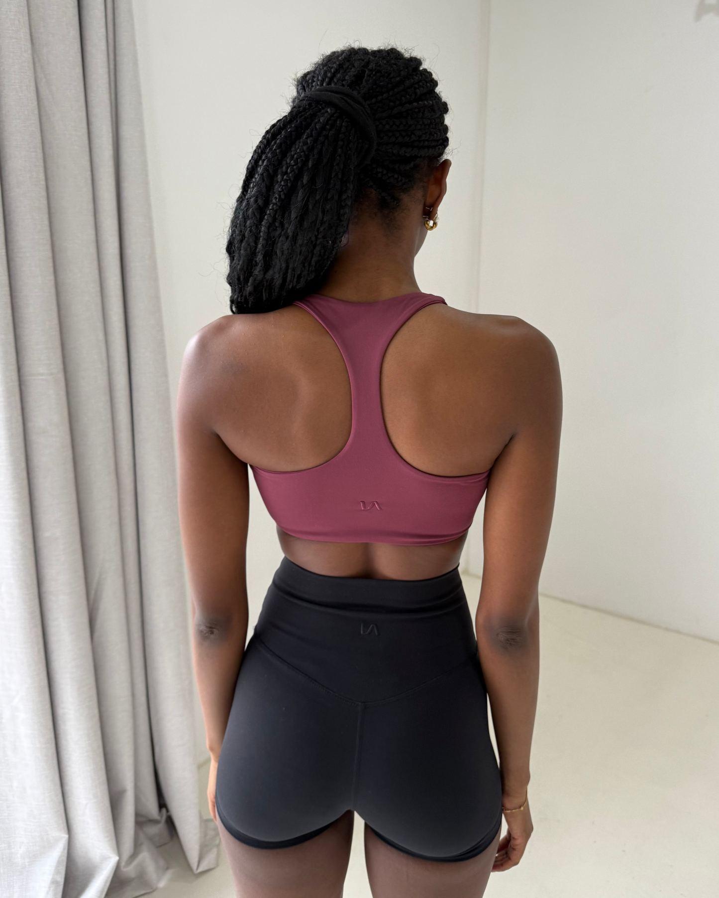 Close up back shot of sports bra with minimal embroidered logo in stitching